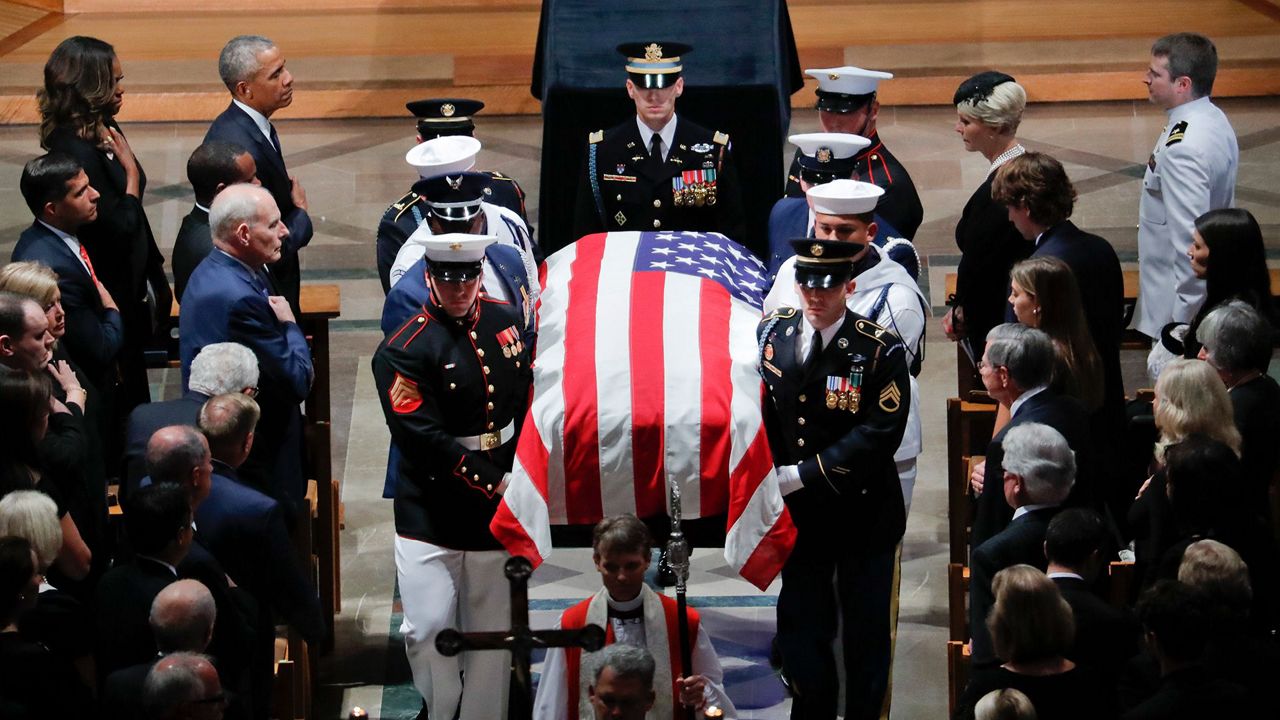 A casket draped with an American flag.