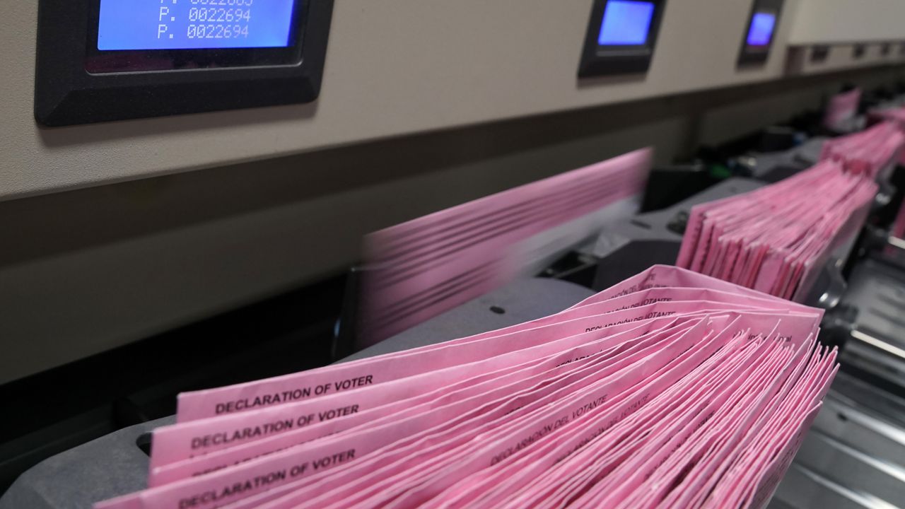 Mail in ballots run through a sorting machine at the Sacramento County Registrar of Voters office in Sacramento, Calif. (AP Photo/Rich Pedroncelli)