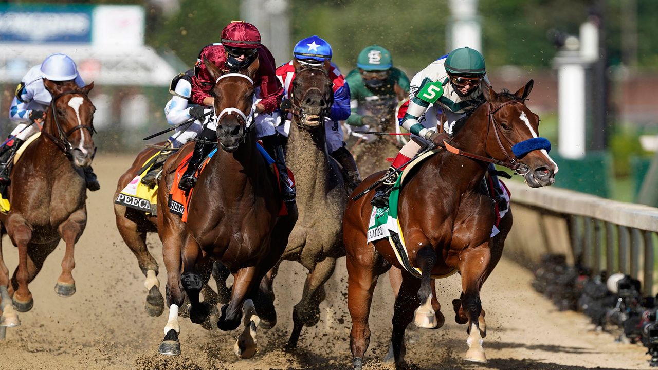 Florent Geroux, who rode Cyberknife in the Arkansas Derby, rides Shedaresthedevil, second left, and John Velazquez rides Gamine, right, going into the first turn during the 146th running of the Kentucky Oaks at Churchill Downs, Friday, Sept. 4, 2020, in Louisville, Ky. (AP Photo/Mark Humphrey)