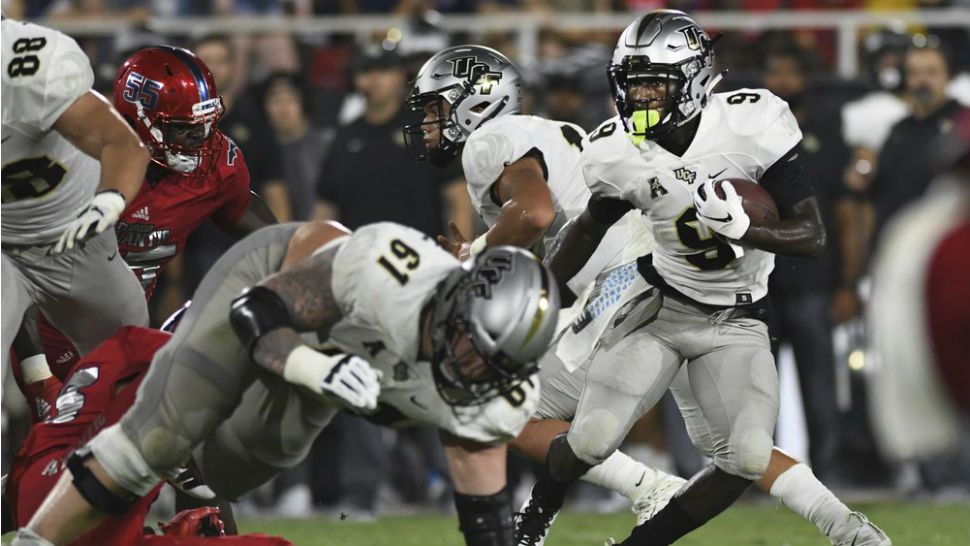 UCF running back Adrian Killins Jr. (9) looks for some running room against the Florida Atlantic defense during the first half of an NCAA college football game Saturday, Sept. 7, 2019, in Boca Raton, Fla. (AP Photo/Jim Rassol)