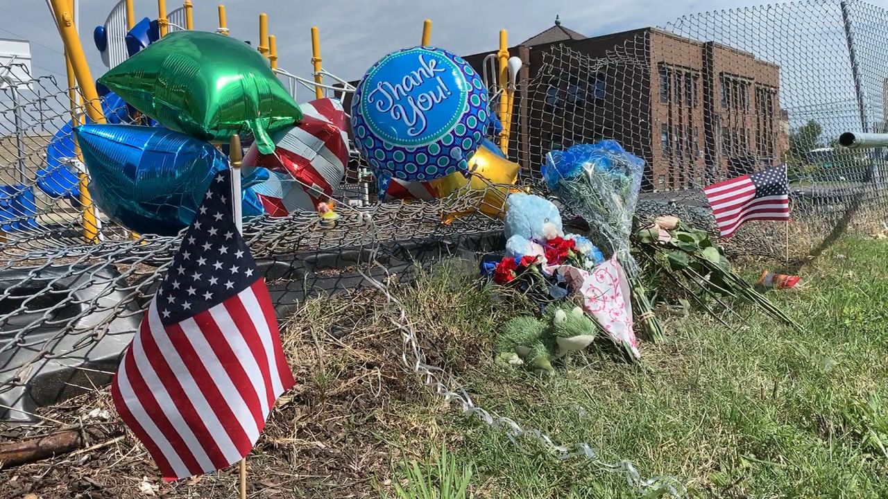 Photo of the fence the car crashed in to, now remembered with a memorial