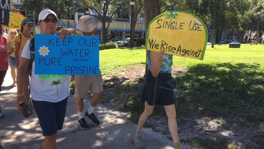 Dozens of residents marched and carried signs, demanding political leaders commit to solutions on climate change. (Katie Jones, Staff)