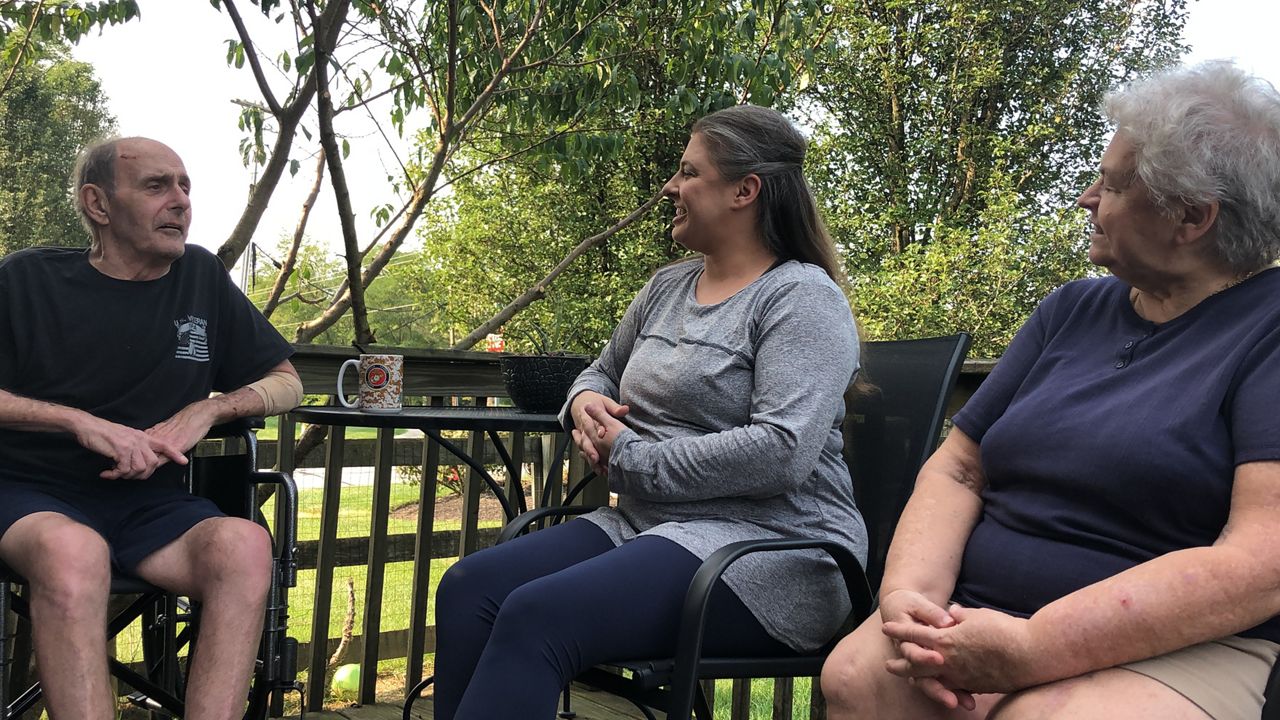 Gregory Rupp sits with his daughter, Rachel, and wife Carol after spending 159 days fighting COVID-19. 