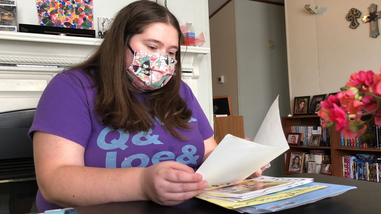 Julia Donohue, 28, sits in her living room reflecting on the letters mailed to her at the hospital during her time battling COVID-19. 