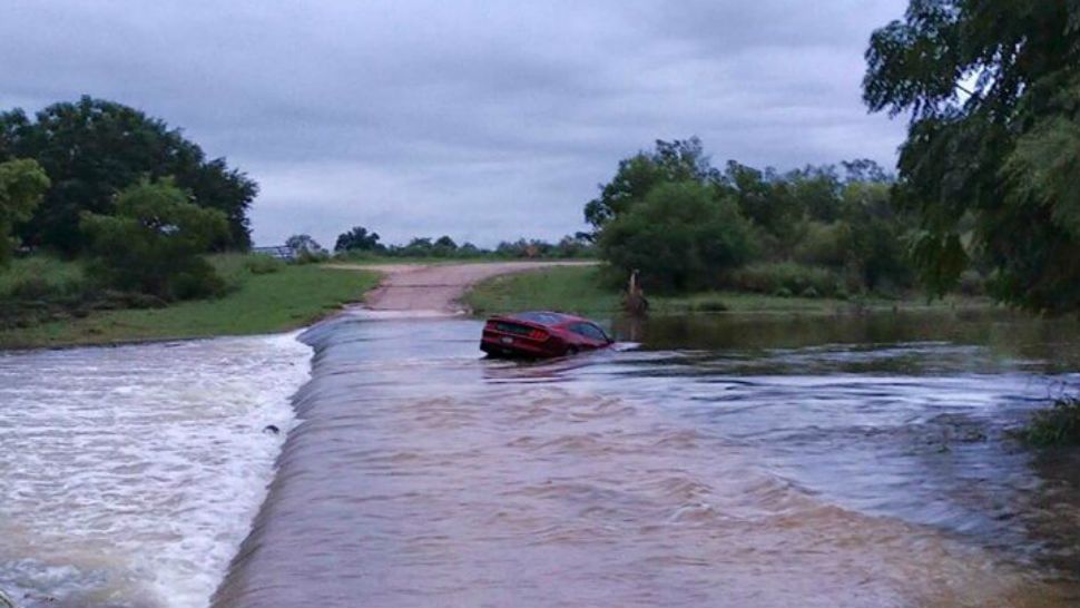 Mustang driver rescued after attempting to cross flooded roadway. (Courtesy: Uvalde County Sheriff's Office Facebook)