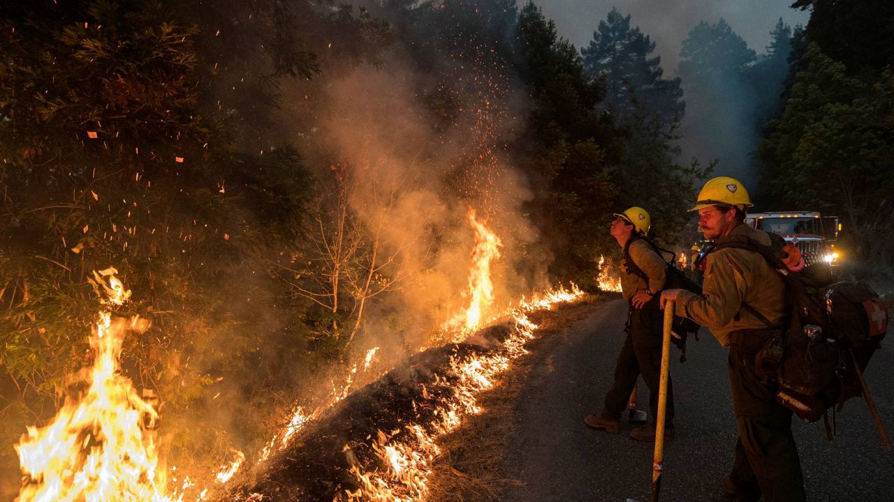 Firefighters monitor a controlled burn along Nacimiento-Fergusson Road to help contain the Dolan Fire near Big Sur, Calif., Sept. 11, 2020. (AP Photo/Nic Coury, File)