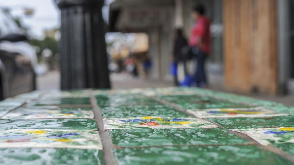 Large droplets of morning rain sit on the tile of a street bench Monday, Sept. 10, 2018, along Elizabeth Street in Brownsville, Texas. Abundant topical moisture is expected to cause additional rainfall and a possible development may form in the Gulf of Mexico within the next week. (Jason Hoekema/The Brownsville Herald via AP)