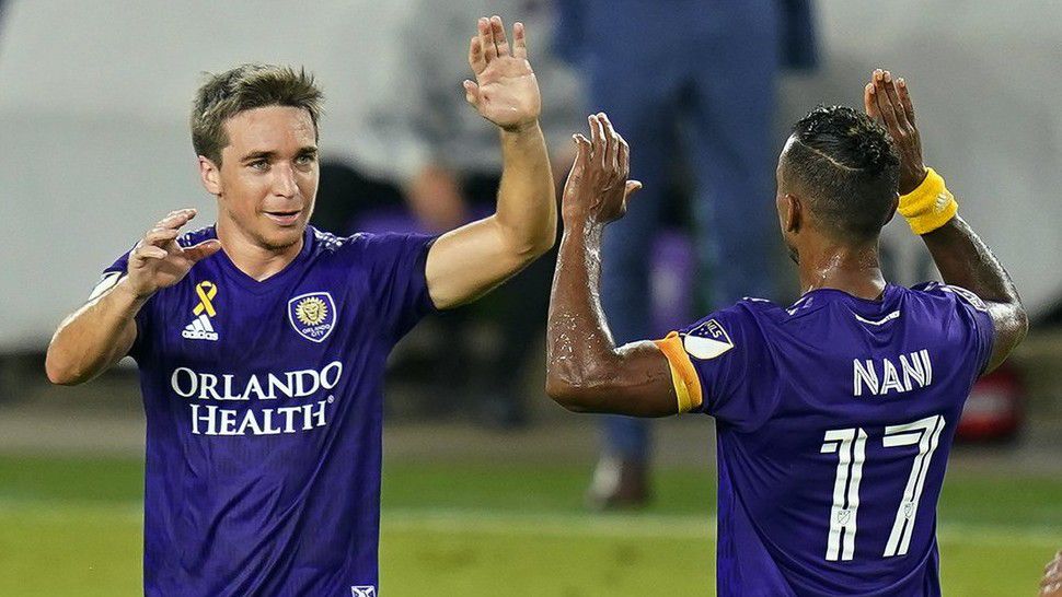 Orlando City's Mauricio Pereyra, left, celebrates his goal against Inter Miami with forward Nani (17) during the first half of an MLS soccer match Saturday, Sept. 12, 2020, in Orlando, Fla. (AP Photo/John Raoux)
