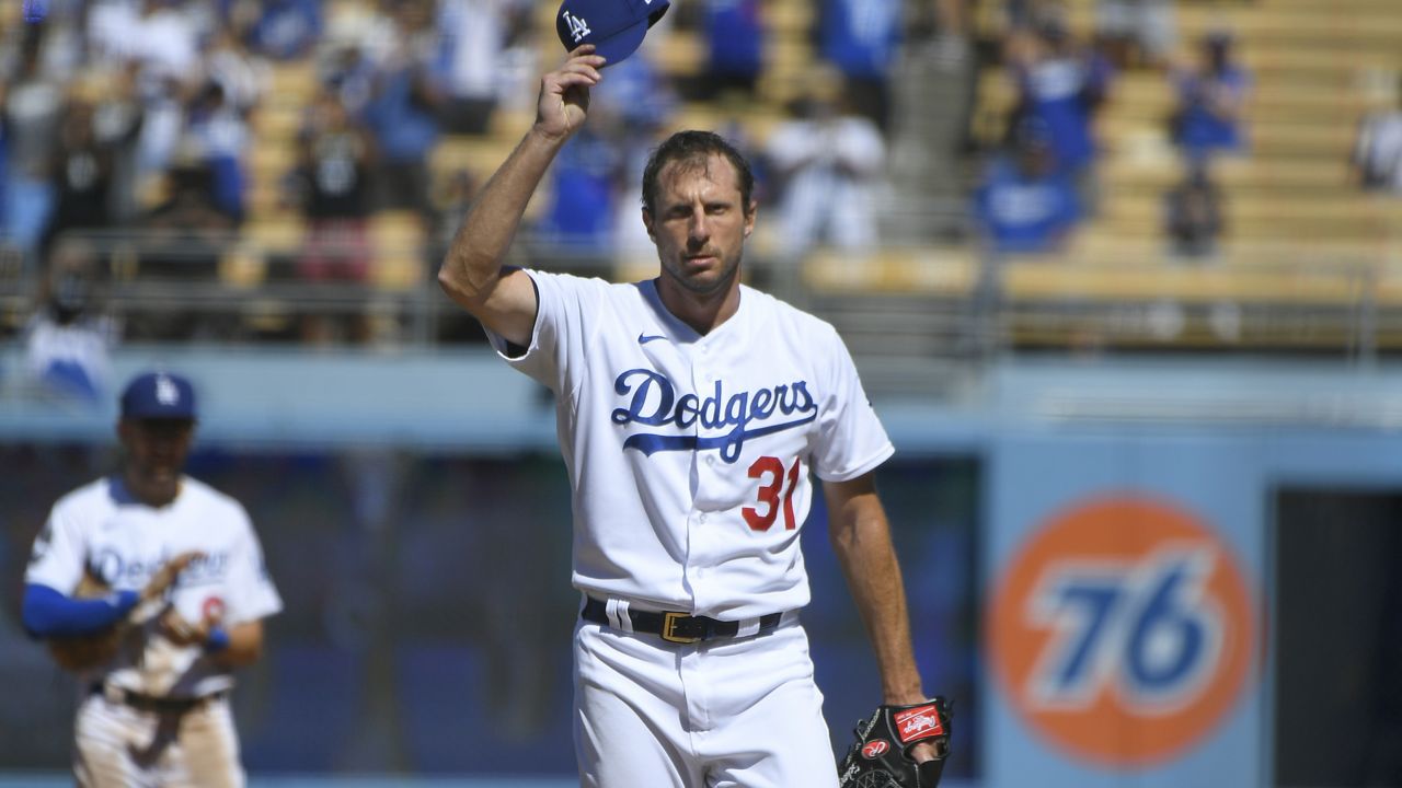 Los Angeles Dodgers Max Scherzer tips his cap after he pitched his 3000th career strikeout against San Diego Padres first baseman Eric Hosmer in the fifth inning during in a baseball game Sunday, Sept. 12, 2021, in Los Angeles, Calif. (AP Photo/John McCoy)