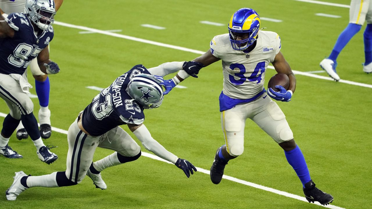 Los Angeles Rams running back Malcolm Brown (34) runs around Dallas Cowboys safety Darian Thompson (23) to score a touchdown during the second half of an NFL football game Sunday, Sept. 13, 2020, in Inglewood, Calif. (AP Photo/Ashley Landis)