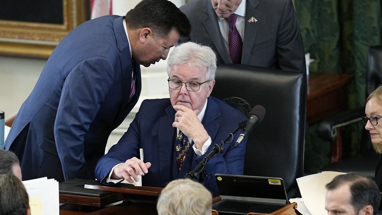 Texas Lt. Gov. Dan Patrick, center, talks with defense counsel and prosecution counsel during the impeachment trial for Texas Attorney General Ken Paxton in the Senate Chamber at the Texas Capitol, Tuesday, Sept. 12, 2023, in Austin, Texas. (AP Photo/Eric Gay)