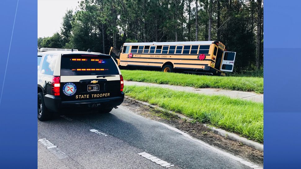 A Pasco County school bus driver was cited for failure to yield after causing a crash with a dump truck Thursday morning. (FHP)