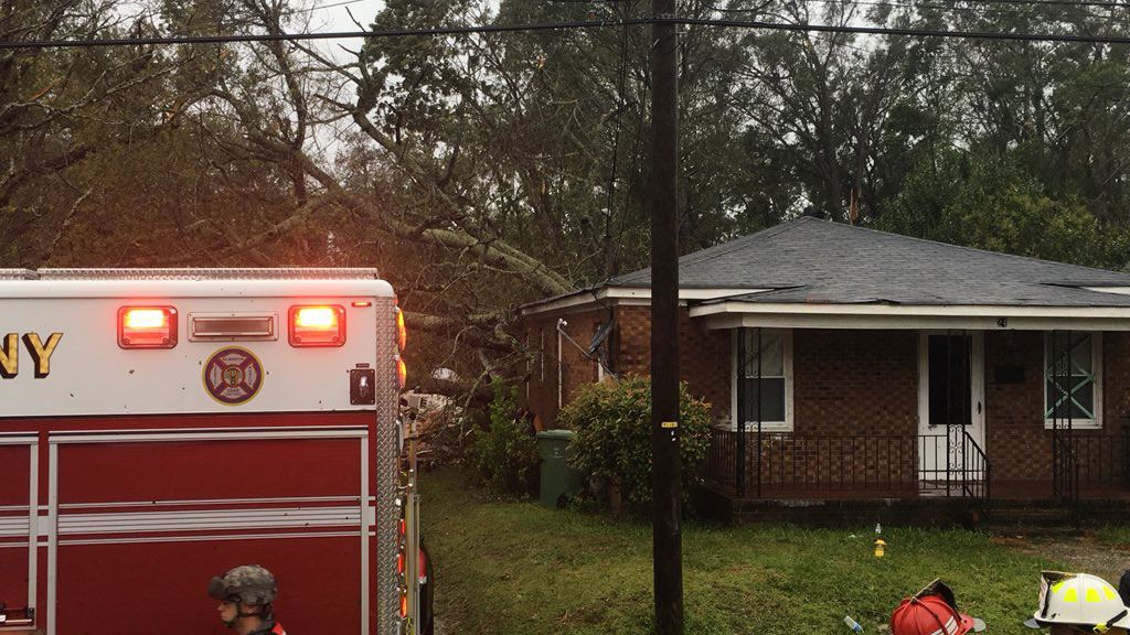 Wilmington crews work to rescue a family who became trapped when a tree fell on their home Friday. Two people died. (Shannon Delaney, Staff)
