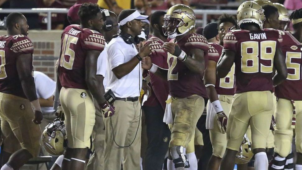 Florida State coach Willie Taggart, center, talks with quarterback Deondre Francois during the fourth quarter of an NCAA college football game against Samford, Saturday, Sept. 8, 2018, in Tallahassee Fla. Florida State won 36-26. (AP Photo/Steve Cannon)