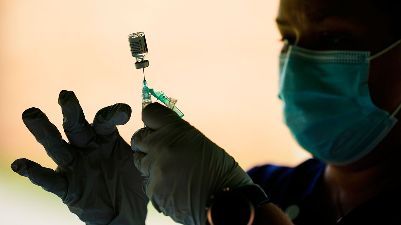A health care worker fills a syringe with the Pfizer-BioNTech COVID-19 vaccine (AP Photo, File)