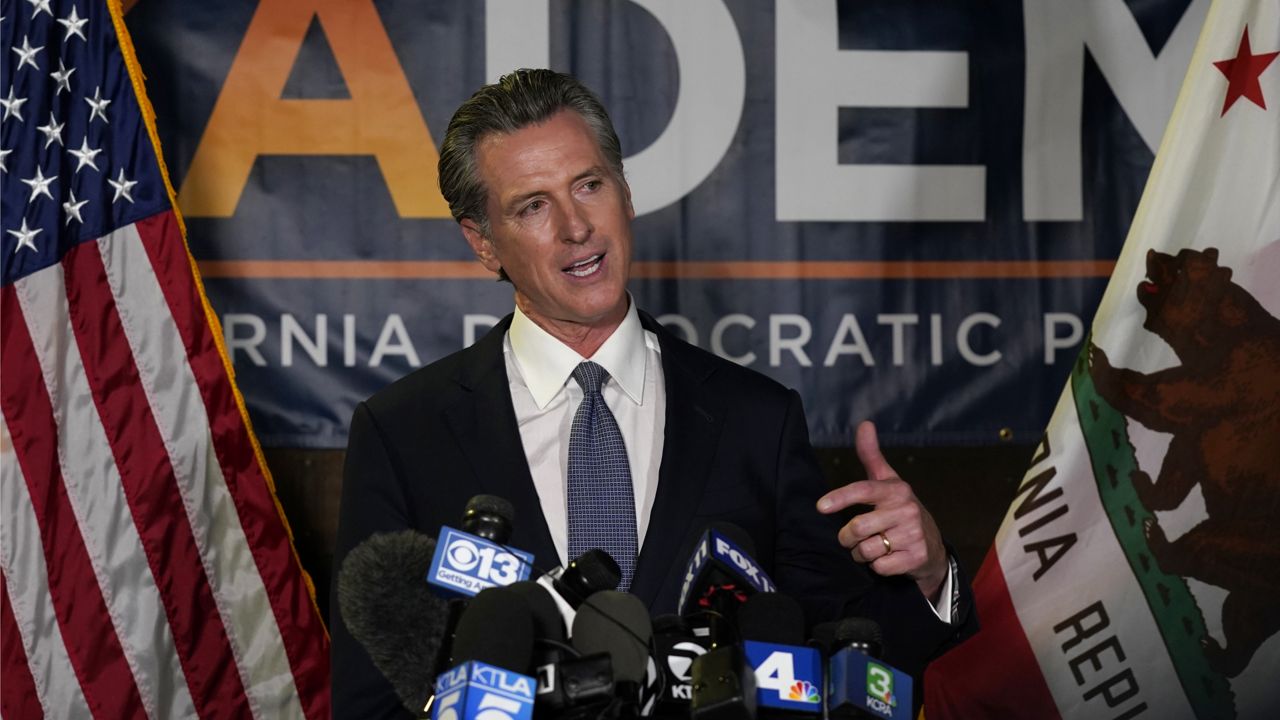 California Gov. Gavin Newsom addresses reporters after beating back the recall that aimed to remove him from office at the John L. Burton California Democratic Party headquarters in Sacramento, Calif., Tuesday, Sept. 14, 2021. (AP Photo/Rich Pedroncelli)