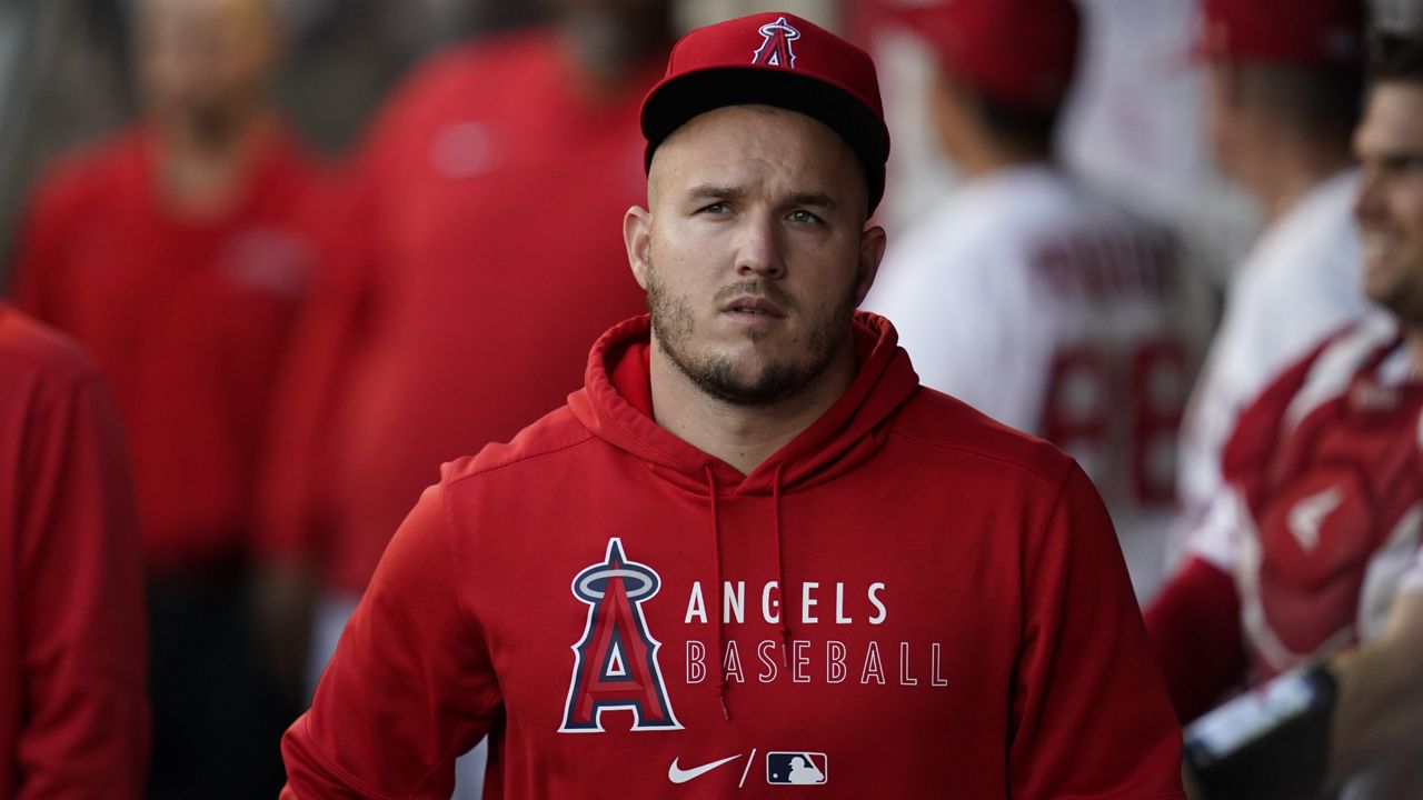 Los Angeles Angels' Mike Trout walks in the dugout before a baseball game against the Texas Rangers Friday, Sep. 3, 2021, in Anaheim, Calif. (AP Photo/Ashley Landis)