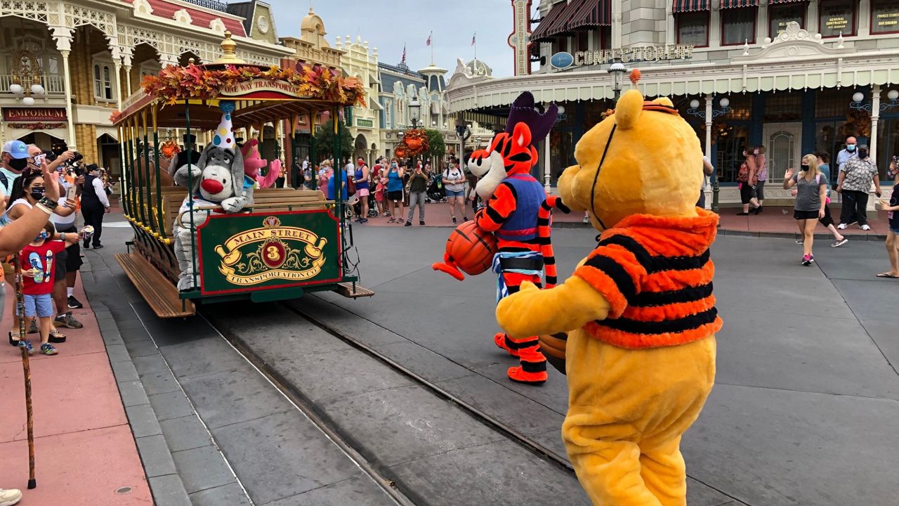 Winnie the Pooh and friends wave to visitors at Magic Kingdom during a Halloween-themed cavalcade down Main Street, U.S.A. (Ashley Carter/Spectrum News)