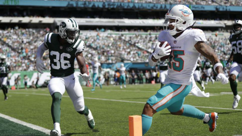 Miami Dolphins’ Albert Wilson (15) runs past New York Jets’ Doug Middleton (36) for a touchdown during the first half of an NFL football game Sunday, Sept. 16, 2018, in East Rutherford, N.J. (AP Photo/Julio Cortez)