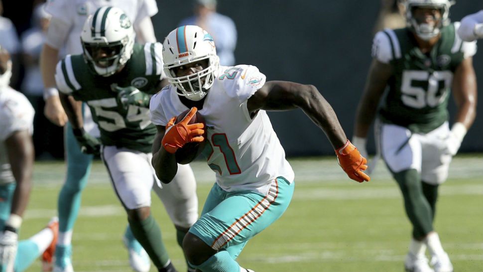FILE - In this Sept. 16, 2018, file photo, Miami Dolphins running back Frank Gore (21) runs against the New York Jets during an NFL football game, in East Rutherford, N.J. Frank Gore's latest 100-yard rushing game was the 46th of his career, and even at age 35, he has no intention of stopping there. (AP Photo/Brad Penner, File)