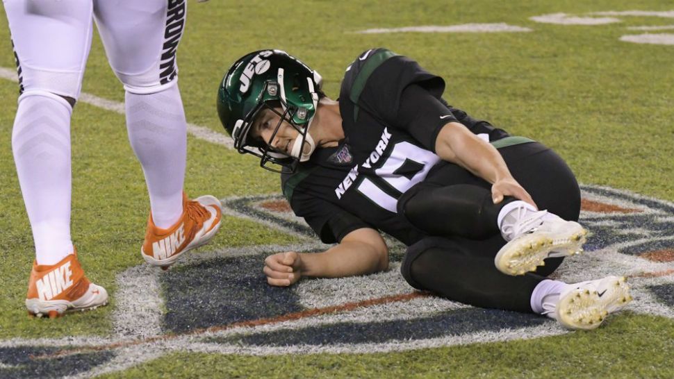 New York Jets quarterback Trevor Siemian (19) grabs his leg after being hurt during the first half of an NFL football game against the Cleveland Browns, Monday, Sept. 16, 2019, in East Rutherford, N.J. (AP Photo/Bill Kostroun)