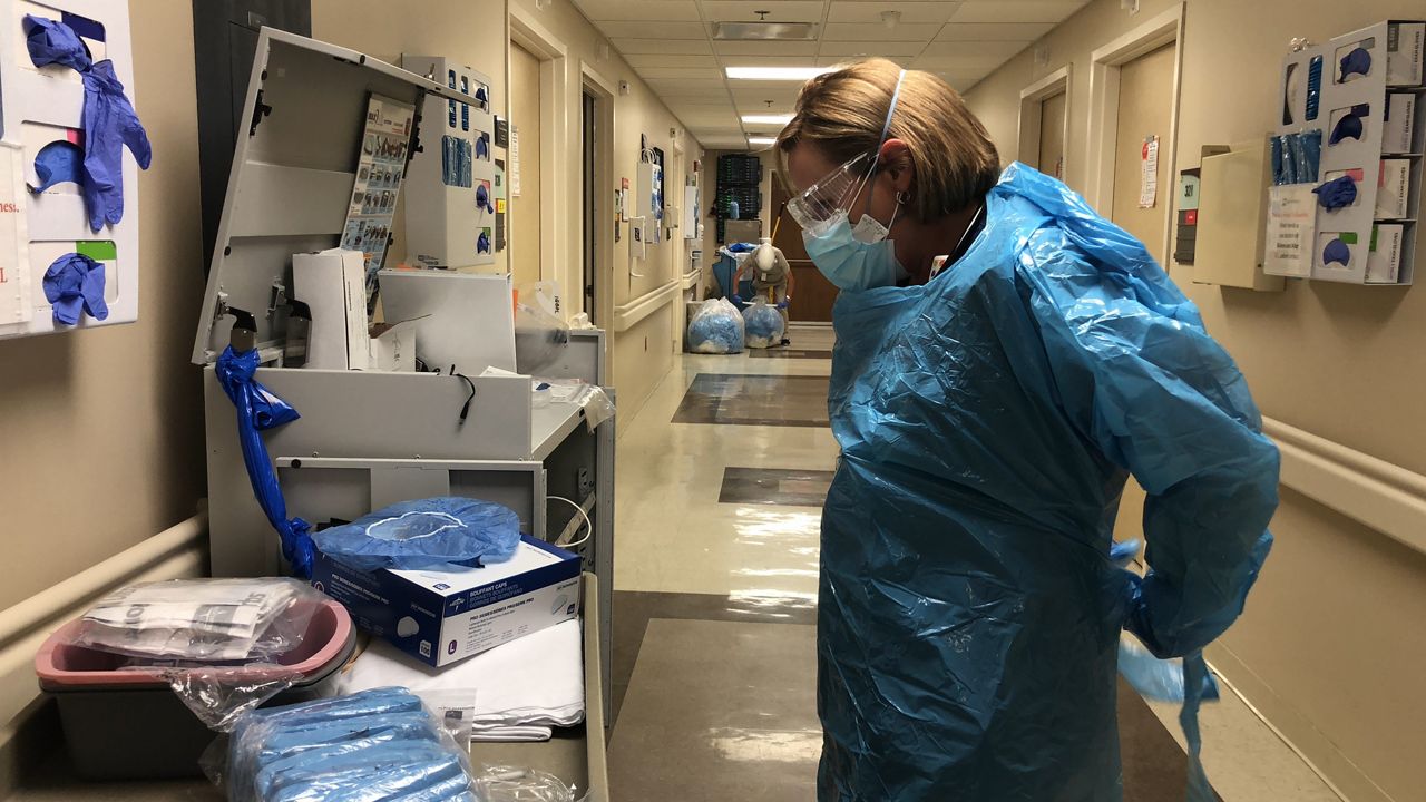 nurse putting on ppe in the hospital