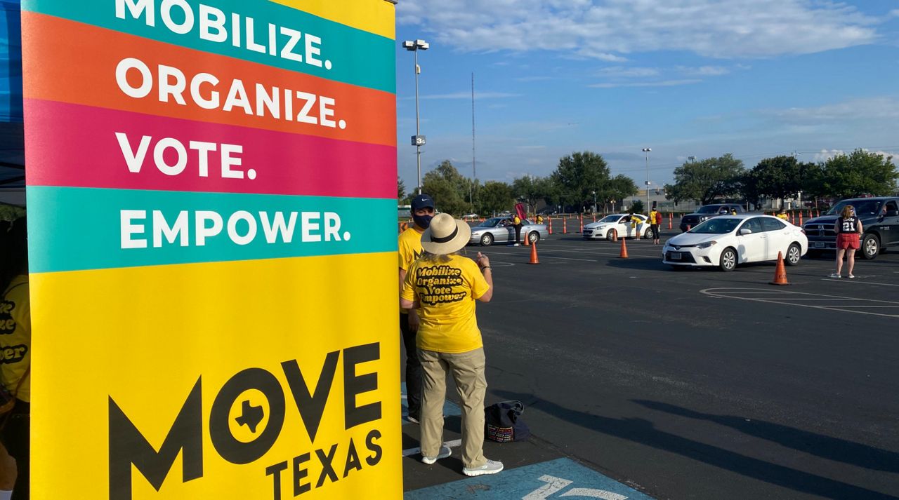 Drive-thru voter registration in the parking lot of the AT&T Center with a MOVE Texas banner (Spectrum News/Brauna Marks)