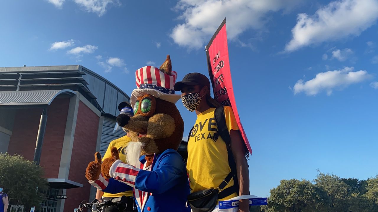 San Antonio Spurs mascot Coyote takes a photo with MOVE Texas volunteers (Spectrum News/Brauna Marks)