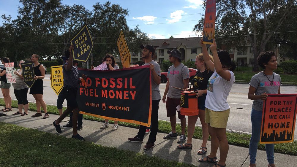 Protesters with the Sunshine Movement outside Rick Scott's event in Orlando Tuesday. (Eugene Buenaventura, Staff)