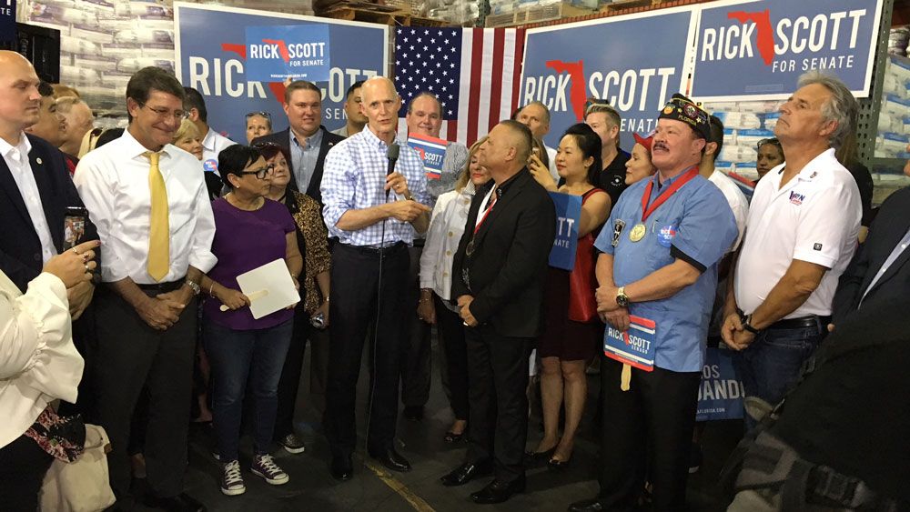 Gov. Rick Scott joined by reporters at a campaign stop in Orlando Tuesday. It was the final stop on his 'Mark Washington Work' bus tour. (Eugene Buenaventura, Staff)