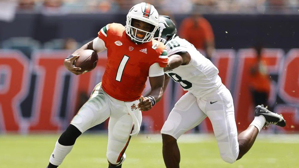 Miami quarterback D'Eriq King (1) breaks a tackle from Michigan State cornerback Kalon Gervin (18) during the second quarter of an NCAA college football game, Saturday, Sept. 18, 2021, in Miami Gardens, Fla. (AP Photo/Michael Reaves)