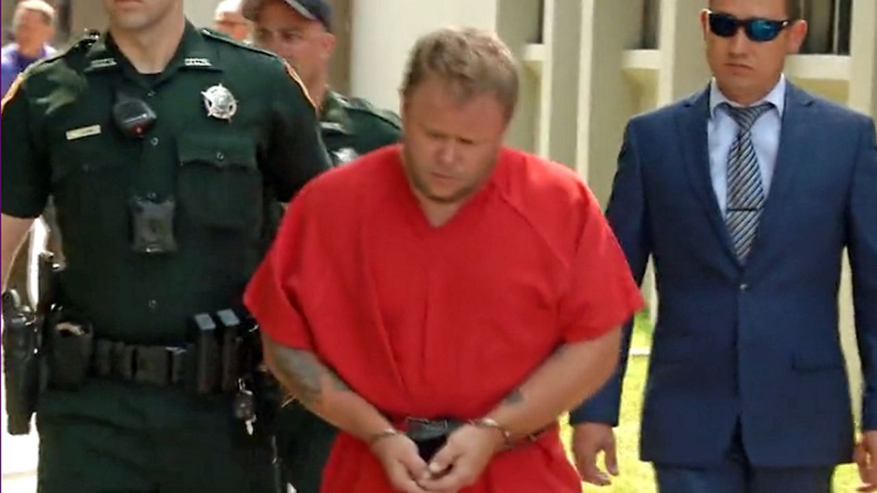 Michael Wayne Jones Jr. is accused of killing his wife and her 4 children and storing their bodies in a van for several weeks. He's seen here in the custody of authorities in Marion County on Wednesday. (Spectrum News)