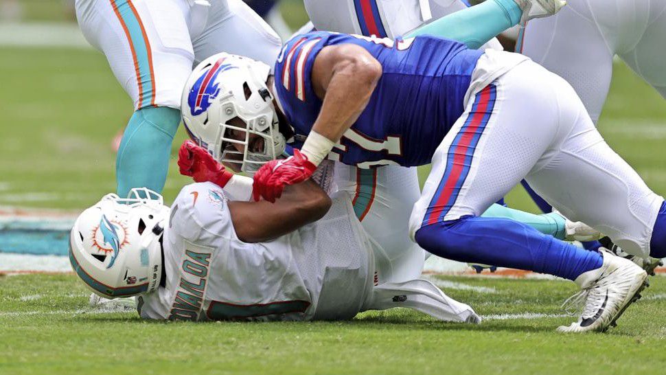 Miami Dolphins quarterback Tua Tagovailoa (1) is sacked by Buffalo Bills defensive end A.J. Epenesa (57) during first half of an NFL football game, Sunday, Sept. 19, 2021, in Miami Gardens, Fla. Tagovailoa was injured on the play. (David Santiago/Miami Herald via AP)