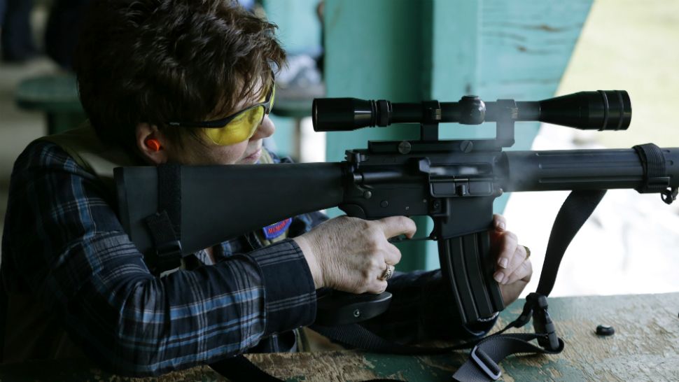 In this file photo from February 2014, then-Washington state Sen. Pam Roach fires a Colt AR-15 semiautomatic rifle at the Evergreen Sportsmen's Club in Olympia, Washington. (AP file)