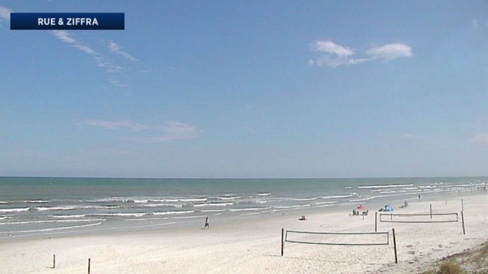 Beachgoers cool off from the heat under clear skies at Daytona Beach on Wednesday. (Sky 13 camera)