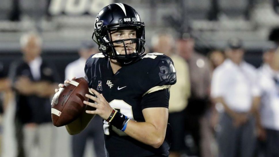 FILE - In this Sept. 21, 2018, file photo, Central Florida quarterback McKenzie Milton looks for a receiver during the first half of an NCAA college football game against Florida Atlantic in Orlando, Fla. Part of the sales pitch that lured Milton from his home state of Hawaii to UCF was a pledge by then-Knights coach Scott Frost to help put the quarterback on a path to a post-playing career in coaching. (AP Photo/John Raoux, File)