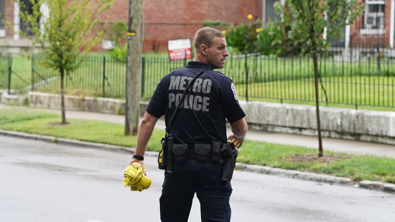 louisville metro police officer walking in a street