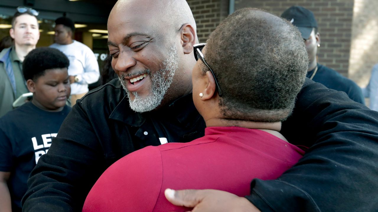 Desmond Meade hugs Melanie Campbell with the National Coalition Black Civic Participation after registering to vote at the Supervisor of Elections office in Orlando, Florida, on Tuesday, January 8, 2019. Meade is a former felon who is president of the Florida Rights Restoration Coalition. (John Raoux/AP)