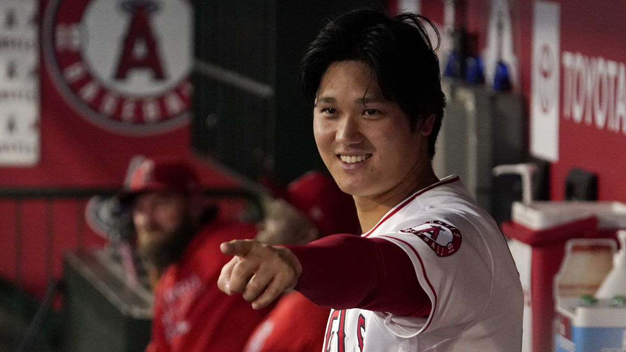 Los Angeles Angels designated hitter Shohei Ohtani gestures to other players in the dugout during the first inning of a baseball game against the Houston Astros Thursday, Sept. 23, 2021, in Anaheim, Calif. (AP Photo/Mark J. Terrill)