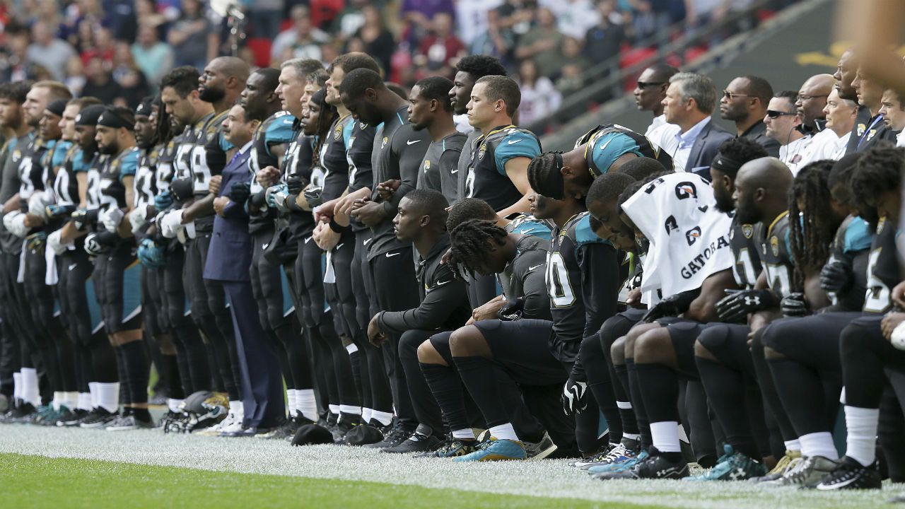 Jacksonville players and coaches kneel during the National Anthem.