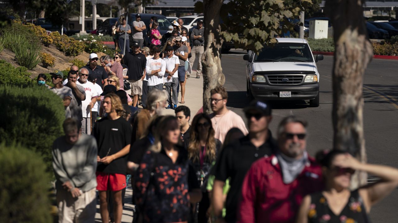 People wait in line to vote outside a vote center Tuesday, Sept. 14, 2021, in Huntington Beach, Calif. (AP Photo/Jae C. Hong)
