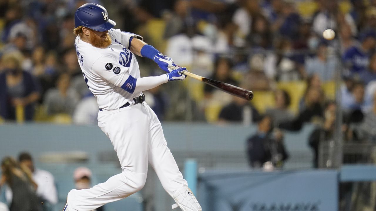 Los Angeles Dodgers' Justin Turner hits a home run during the fourth inning of a baseball game against the San Diego Padres Thursday, Sept. 30, 2021, in Los Angeles. (AP Photo/Ashley Land