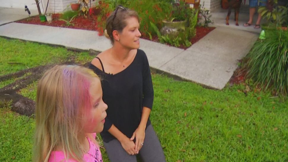 L to R: Emily and her mom, Jennifer Keller, were out in their front yard Wednesday afternoon when a drive-by shooting took place in their Valrico neighborhood just a block away from their home. (Spectrum Bay News 9)