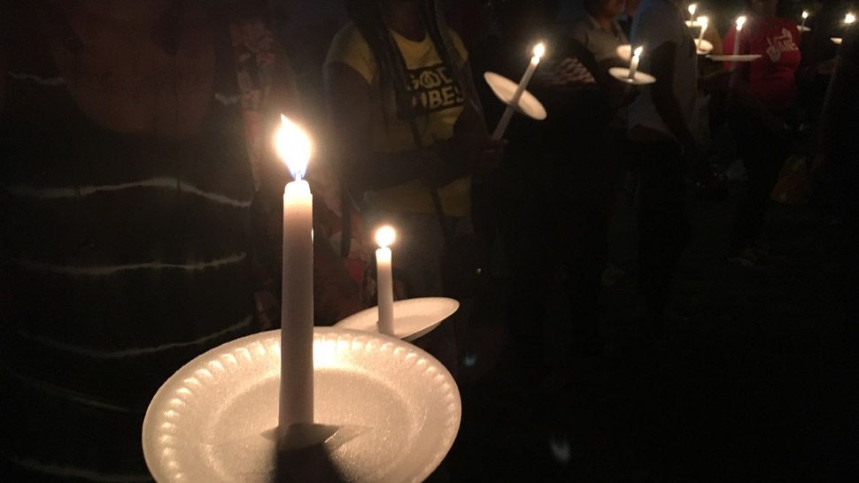 Family, friends, and community members hold candles in honor of Tymira Leverson, who died after she was struck by a car while walking with her children on U.S. 19 on September 22. (Laurie Davison/Spectrum Bay News 9)
