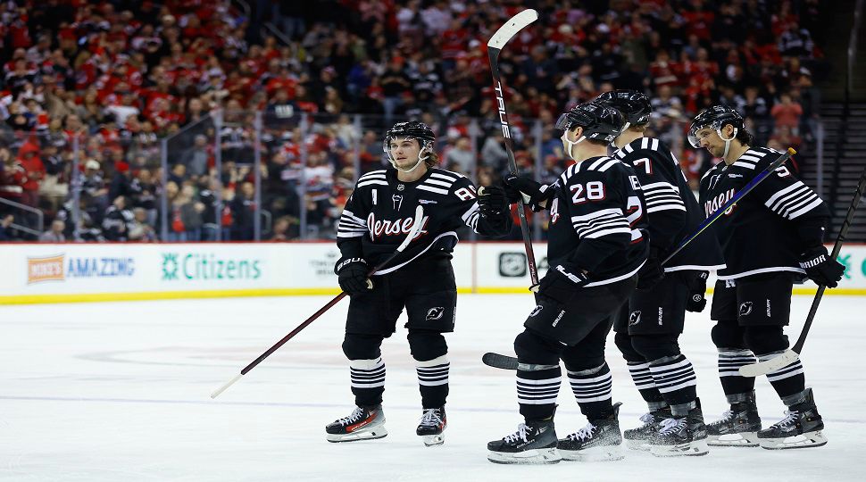 New Jersey Devils center Jack Hughes (86) celebrates with teammates after scoring a goal against the Tampa Bay Lightning during the second period of an NHL hockey game, Saturday, Jan. 11, 2025, in Newark, N.J. (AP Photo/Noah K. Murray)