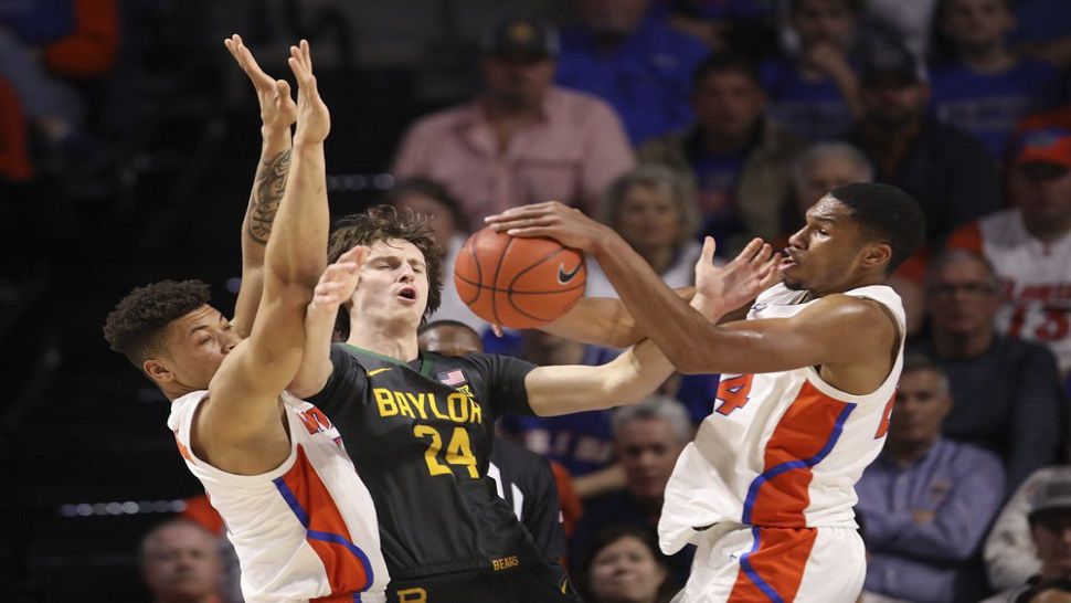 Florida forward Kerry Blackshear Jr. (24) steals the ball from Baylor guard Matthew Mayer during first-half action of Florida's game vs. No. 1 Baylor.  The Gators upset bid fell short, with Baylor winning 72-61 in Gainesville.  (AP Photo/Matt Stamey)