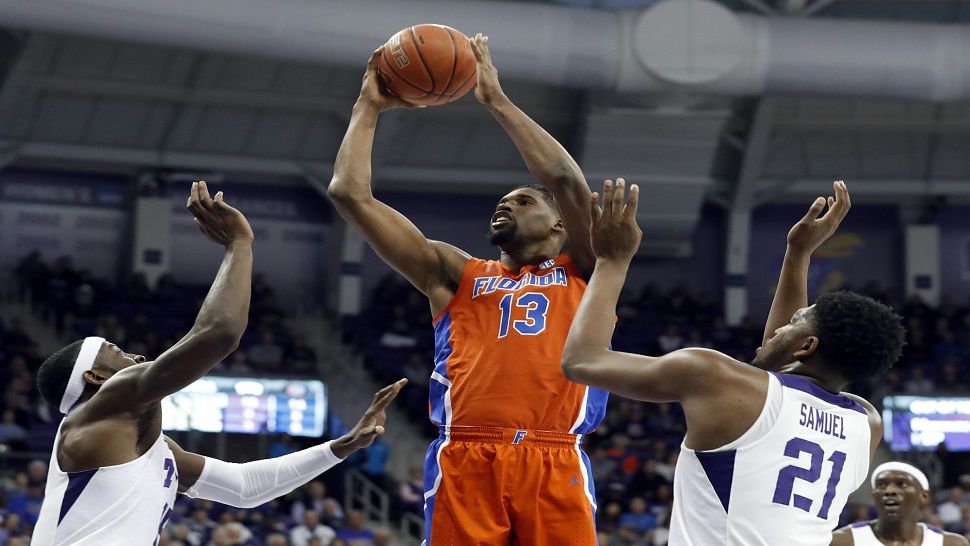 Florida center Kevarrius Hayes attempts a shot over two TCU defenders in the first half of the Gators' 55-50 loss to the Horned Frogs in Fort Worth, TX.  (AP Photo/Tony Gutierrez)