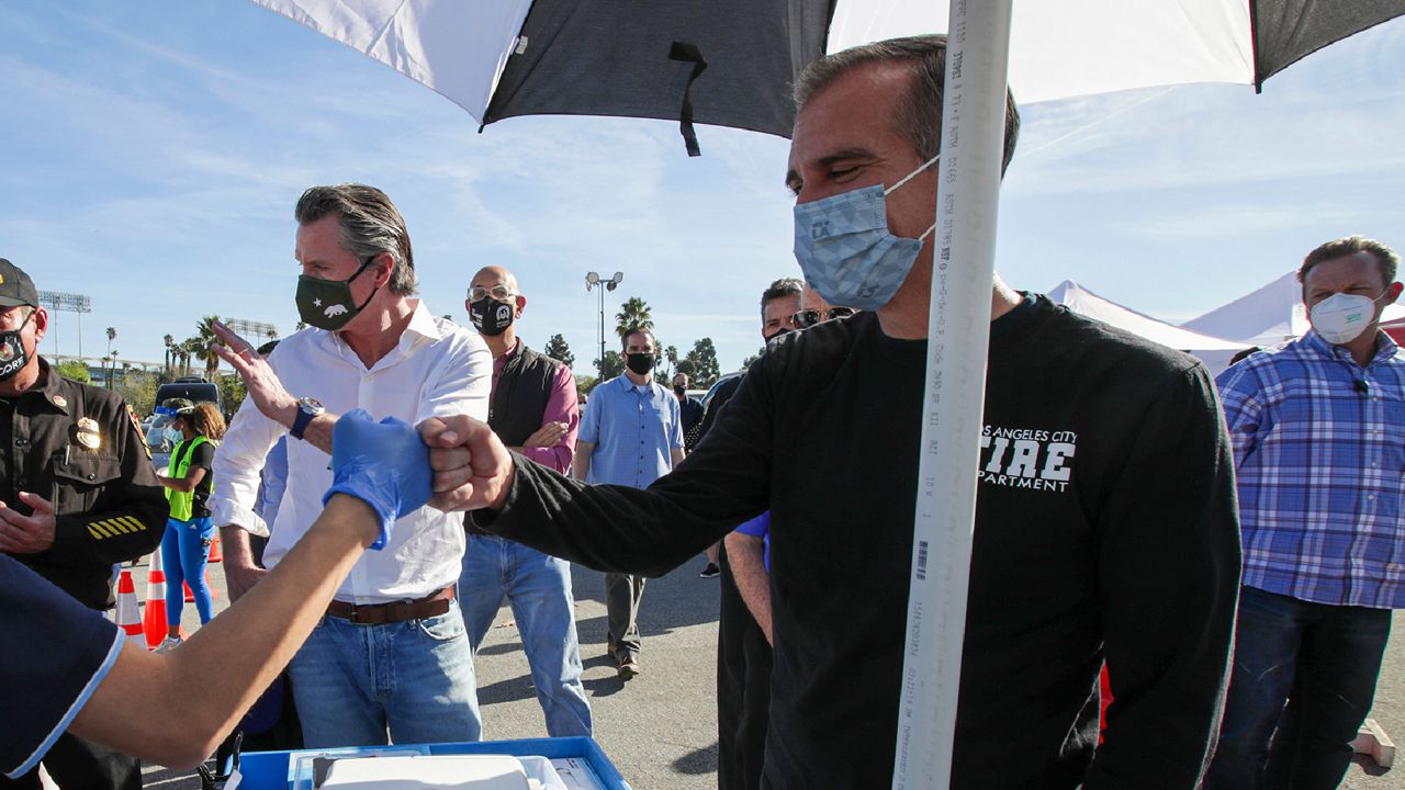 Los Angeles Mayor Eric Garcetti and Gov. Gavin Newsom at the mass COVID-19 vaccination site at Dodger Stadium on Jan. 15, 2021, in Los Angeles. (Irfan Khan/Los Angeles Times via AP, Pool)