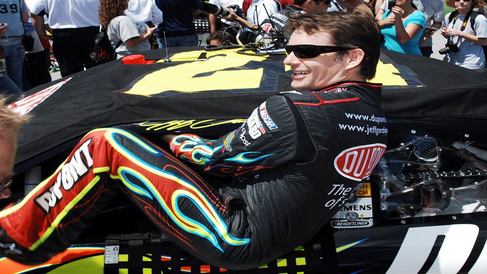 In this 2010 file photo, Jeff Gordon climbs into his car at the start of a Sprint Cup Series race in Talladega, Ala.  Gordon will be inducted into the NASCAR Hall of Fame on Friday night.  (AP Photo/Rainier Ehrhardt, File)