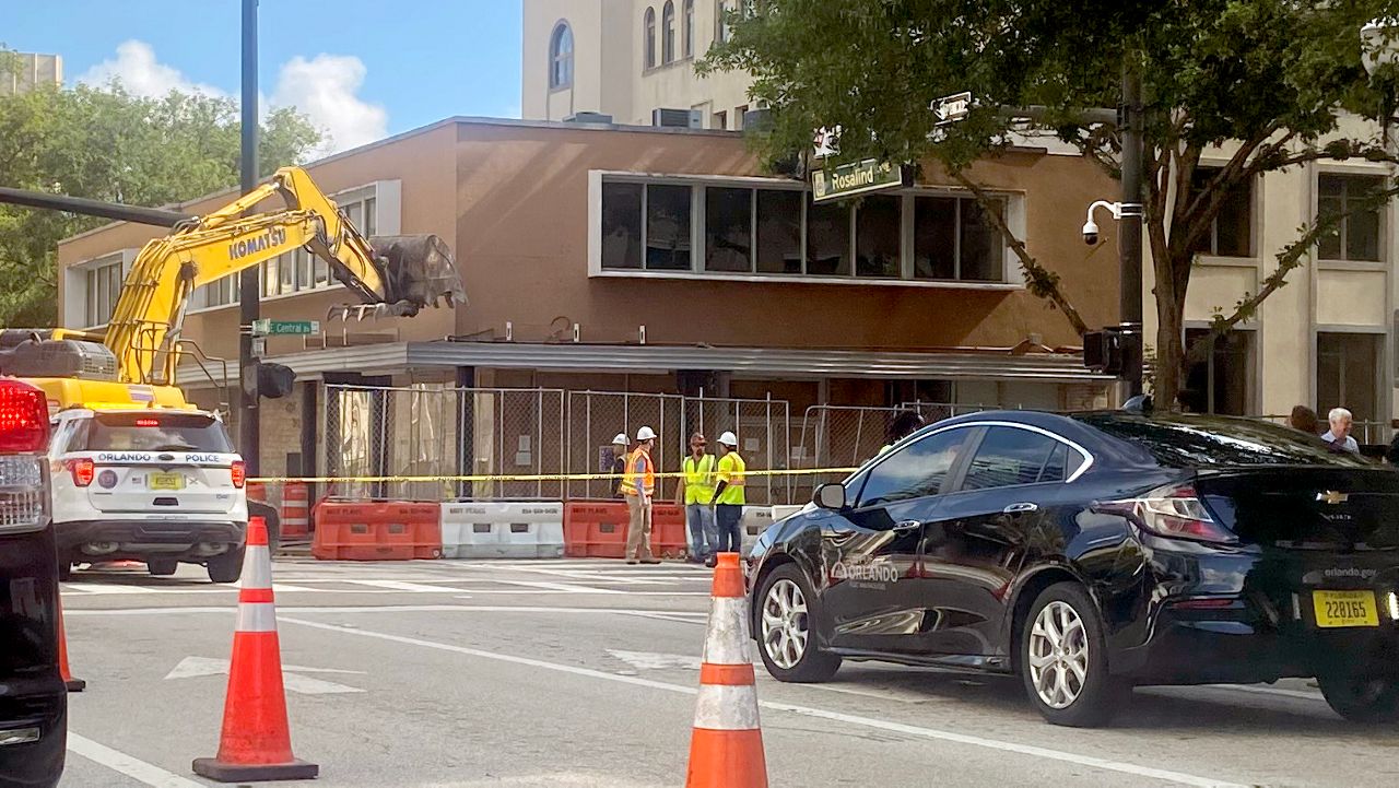 Workers prepare Monday for the demolition of 1 Rosalind Ave., which officials say will clear the way for an expansion of the park around Lake Eola. (Spectrum News 13/Mark Boxley)